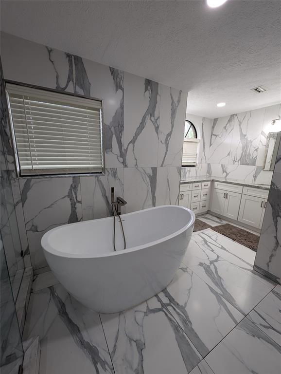 2106 Whitlock Place Dover, FL 33527 - Photo 37 of 83 a bath tub sitting in a bathroom next to a window