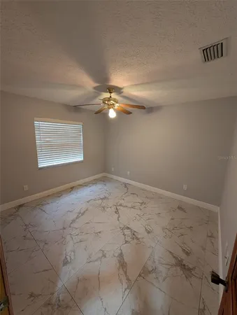 a view of a room with a sink and cabinets