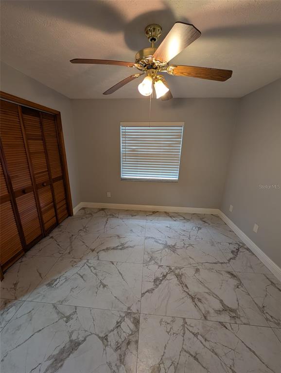 2106 Whitlock Place Dover, FL 33527 - Photo 49 of 83 a view of a livingroom with a chandelier fan and wooden floor