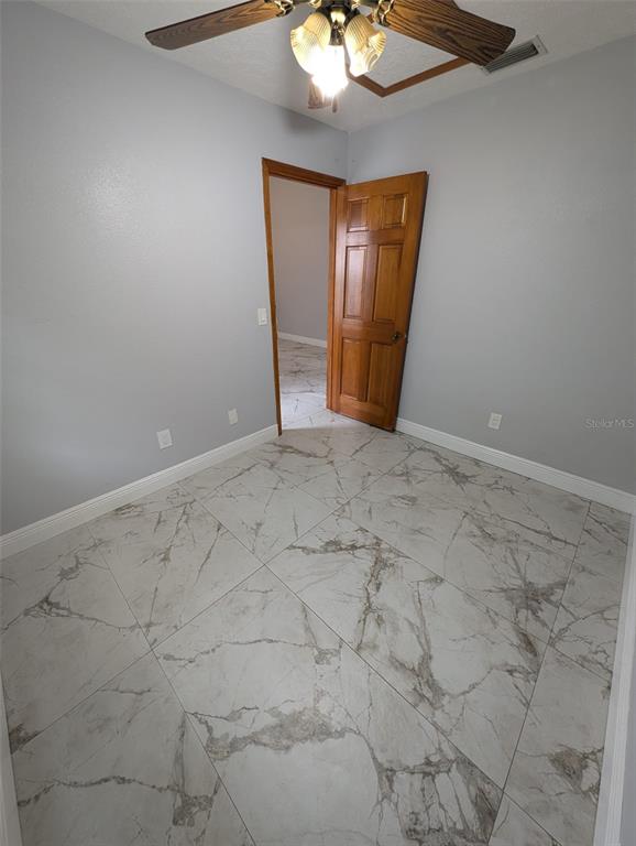 2106 Whitlock Place Dover, FL 33527 - Photo 56 of 83 a view of an empty room with a chandelier fan