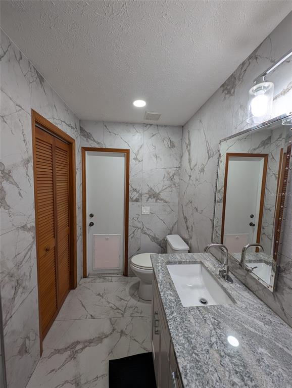 2106 Whitlock Place Dover, FL 33527 - Photo 58 of 83 a bathroom with a granite countertop double vanity sink and mirror