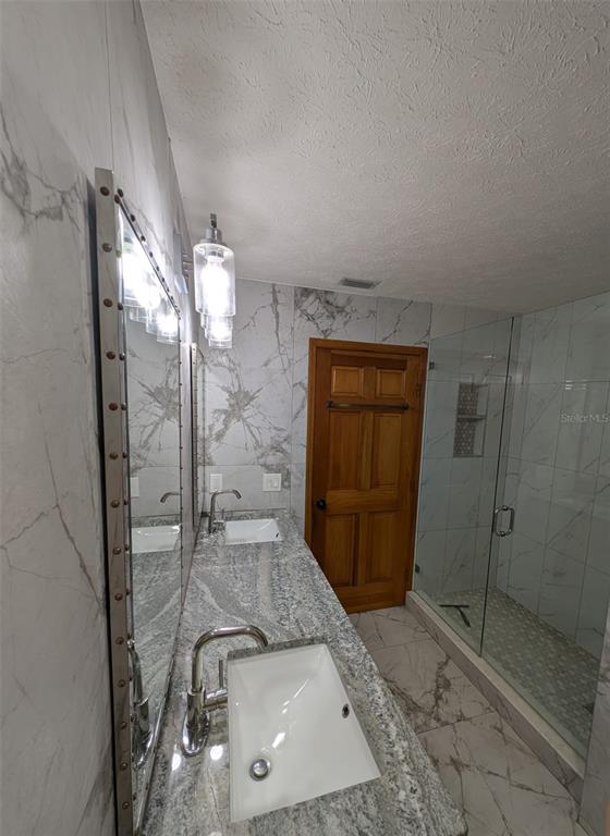 2106 Whitlock Place Dover, FL 33527 - Photo 59 of 83 a bathroom with a sink a toilet and shower