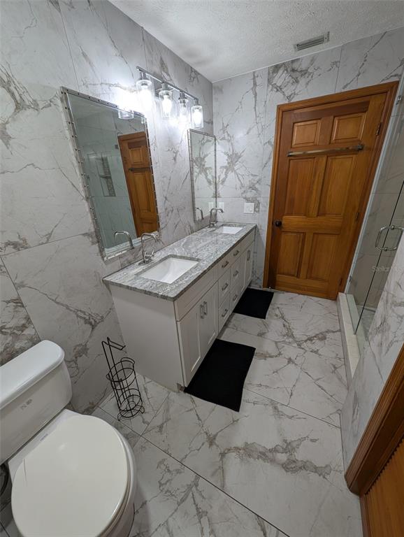 2106 Whitlock Place Dover, FL 33527 - Photo 60 of 83 a bathroom with a sink and mirror with toilet