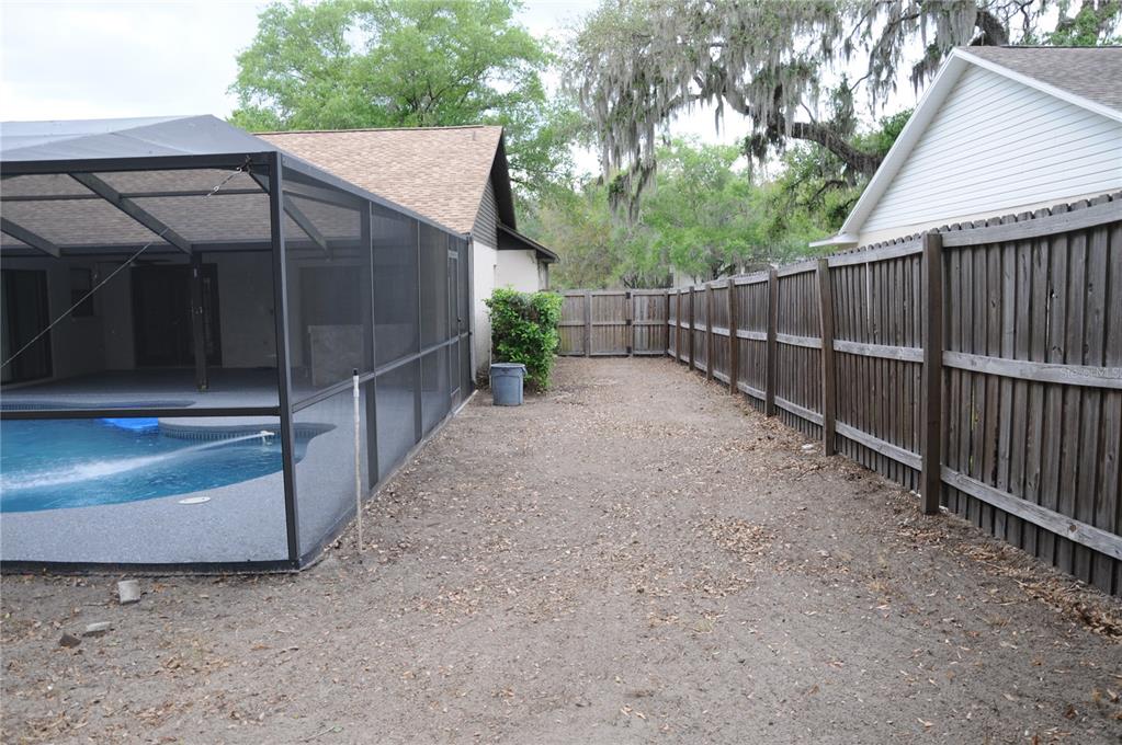 2106 Whitlock Place Dover, FL 33527 - Photo 74 of 83 a view of a barn with a small yard and wooden fence
