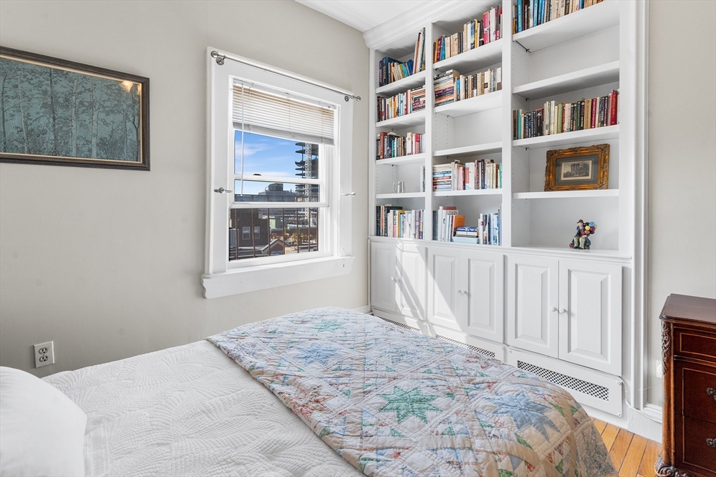 33 Hancock Street, Unit 4 Boston, MA 02114 - Photo 17 of 29 a bedroom with a bed and a book shelf