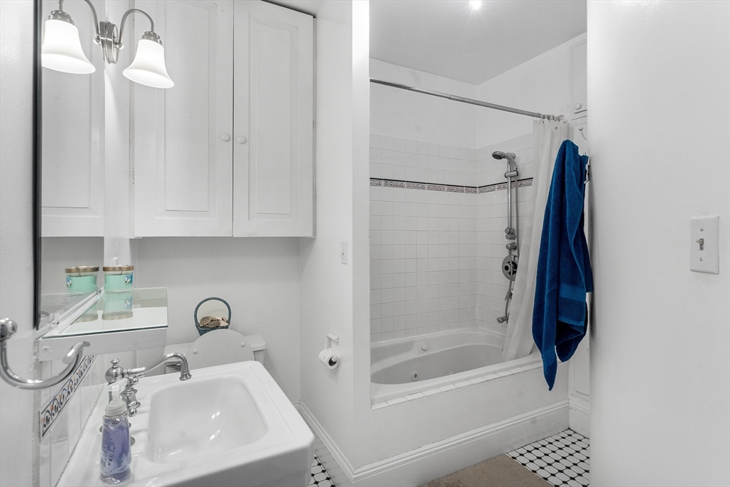 33 Hancock Street, Unit 4 Boston, MA 02114 - Photo 20 of 29 a bathroom with a sink and a mirror