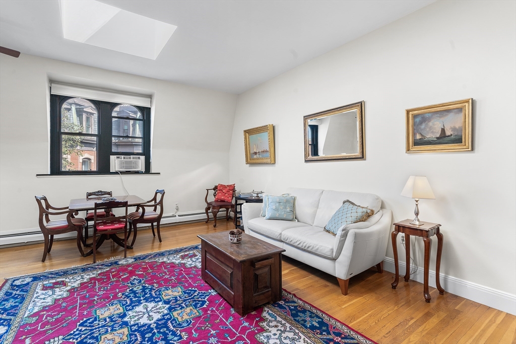 33 Hancock Street, Unit 4 Boston, MA 02114 - Photo 6 of 29 a living room with furniture a rug and a table
