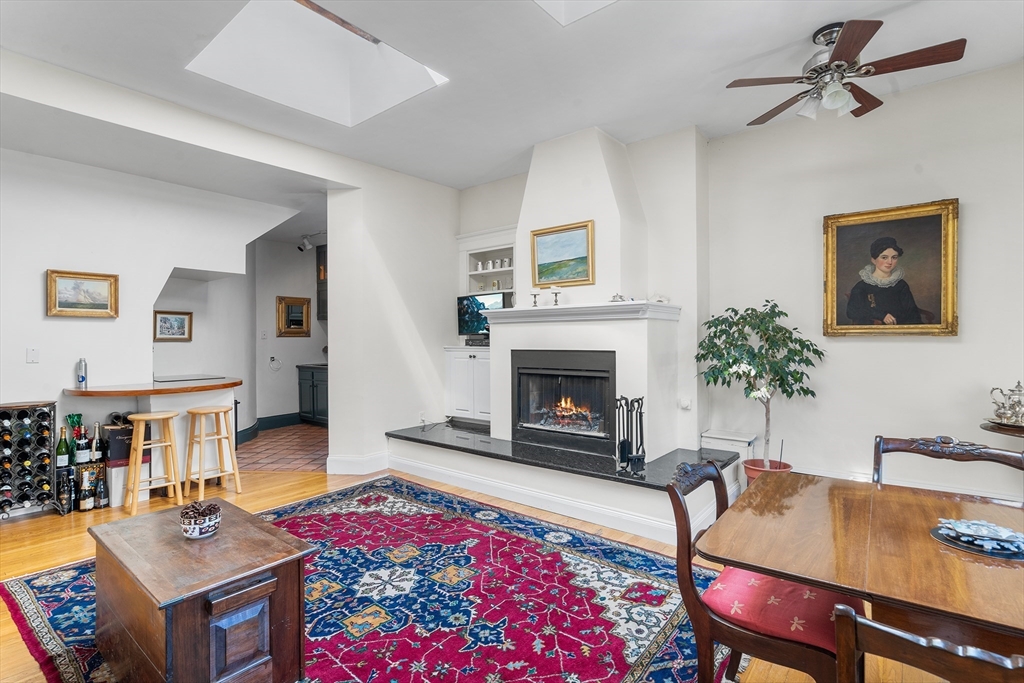 33 Hancock Street, Unit 4 Boston, MA 02114 - Photo 7 of 29 a living room with furniture a rug and a fireplace