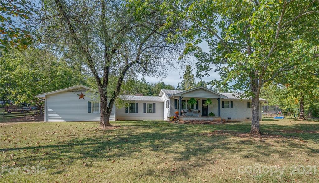455 Sandy Plains Road Tryon, NC 28782 - Photo 1 of 28 a front view of a house with garden