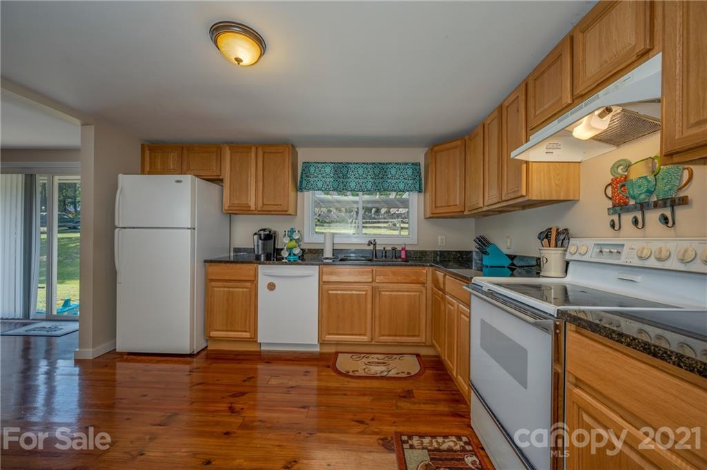 455 Sandy Plains Road Tryon, NC 28782 - Photo 12 of 28 a kitchen with stainless steel appliances granite countertop a refrigerator sink and stove