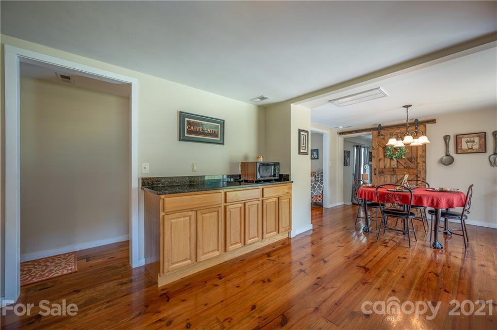 455 Sandy Plains Road Tryon, NC 28782 - Photo 13 of 28 a living room with furniture and a wooden floor