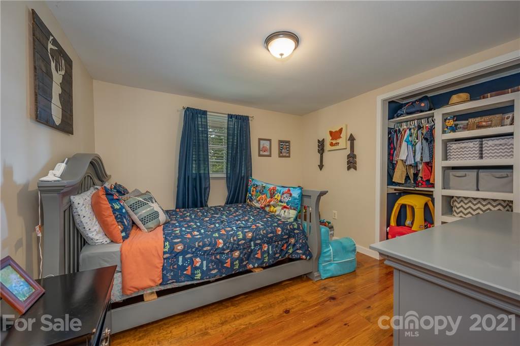 455 Sandy Plains Road Tryon, NC 28782 - Photo 17 of 28 a bedroom with bed and wooden floor