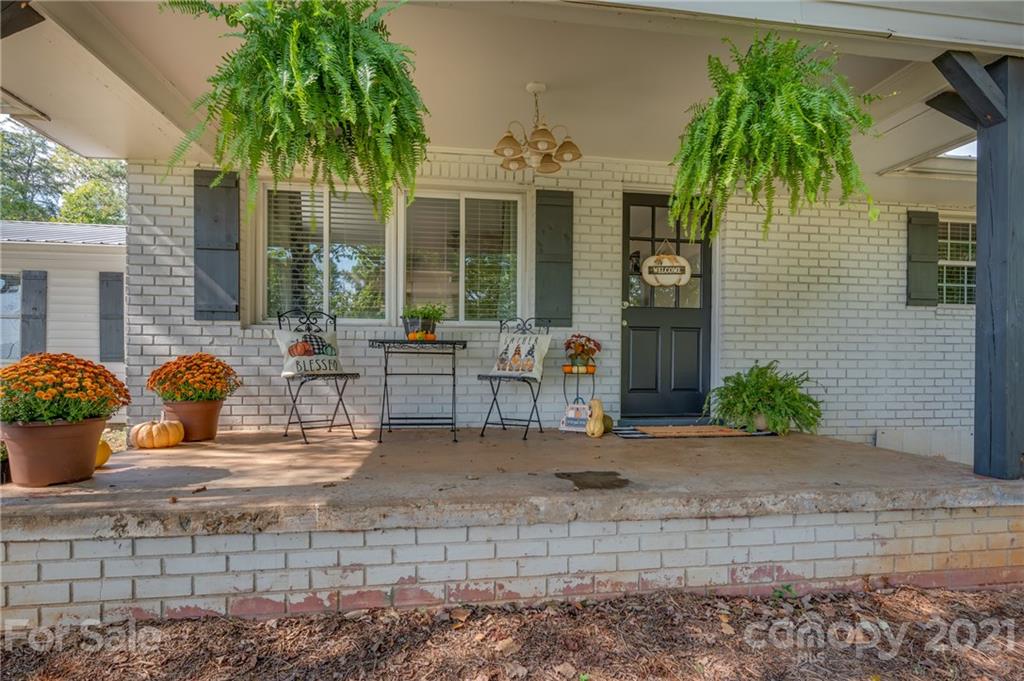 455 Sandy Plains Road Tryon, NC 28782 - Photo 3 of 28 a view of a house with backyard and sitting area