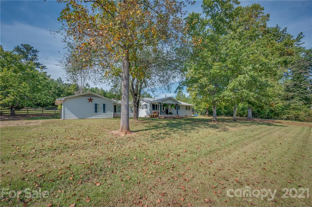 455 Sandy Plains Road Tryon, NC 28782 - Photo 23 of 28 a view of a house with a yard and large tree