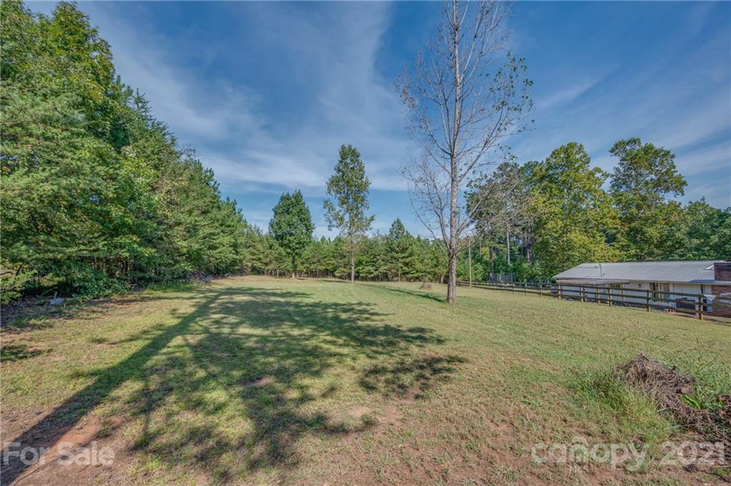455 Sandy Plains Road Tryon, NC 28782 - Photo 26 of 28 a backyard of a house with lots of green space