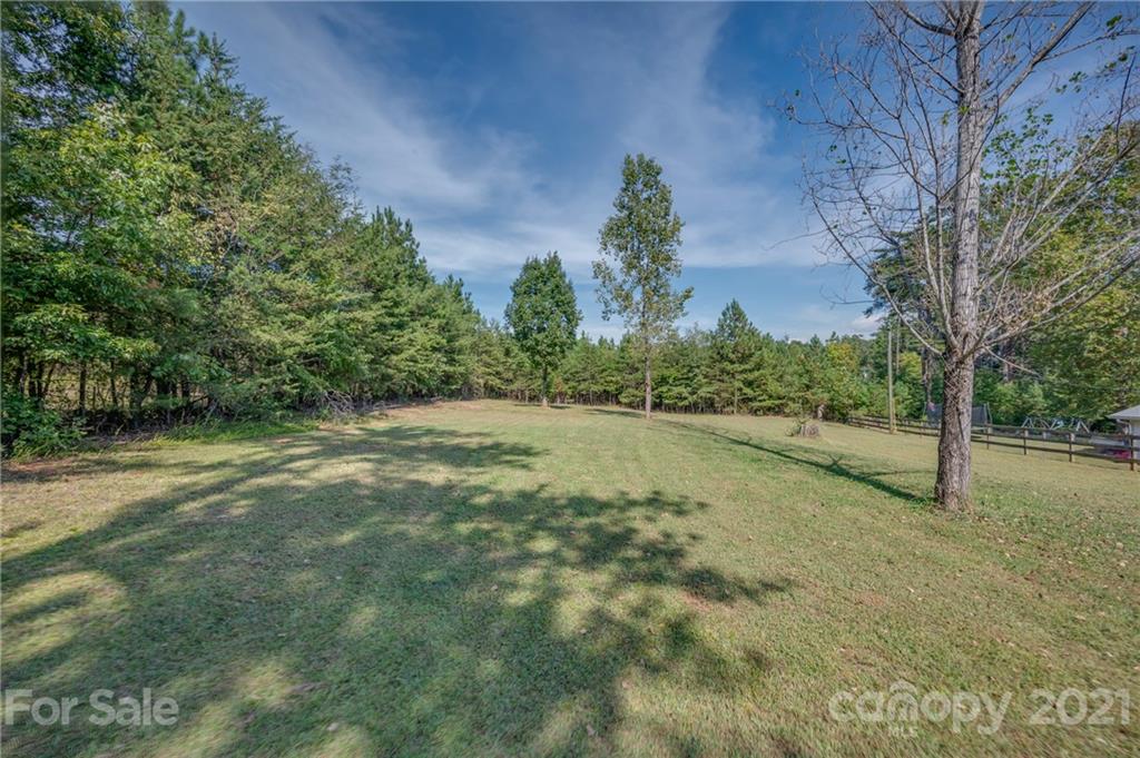 455 Sandy Plains Road Tryon, NC 28782 - Photo 27 of 28 a view of a field with trees in the background