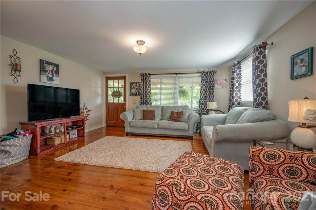 455 Sandy Plains Road Tryon, NC 28782 - Photo 6 of 28 a living room with furniture and a flat screen tv