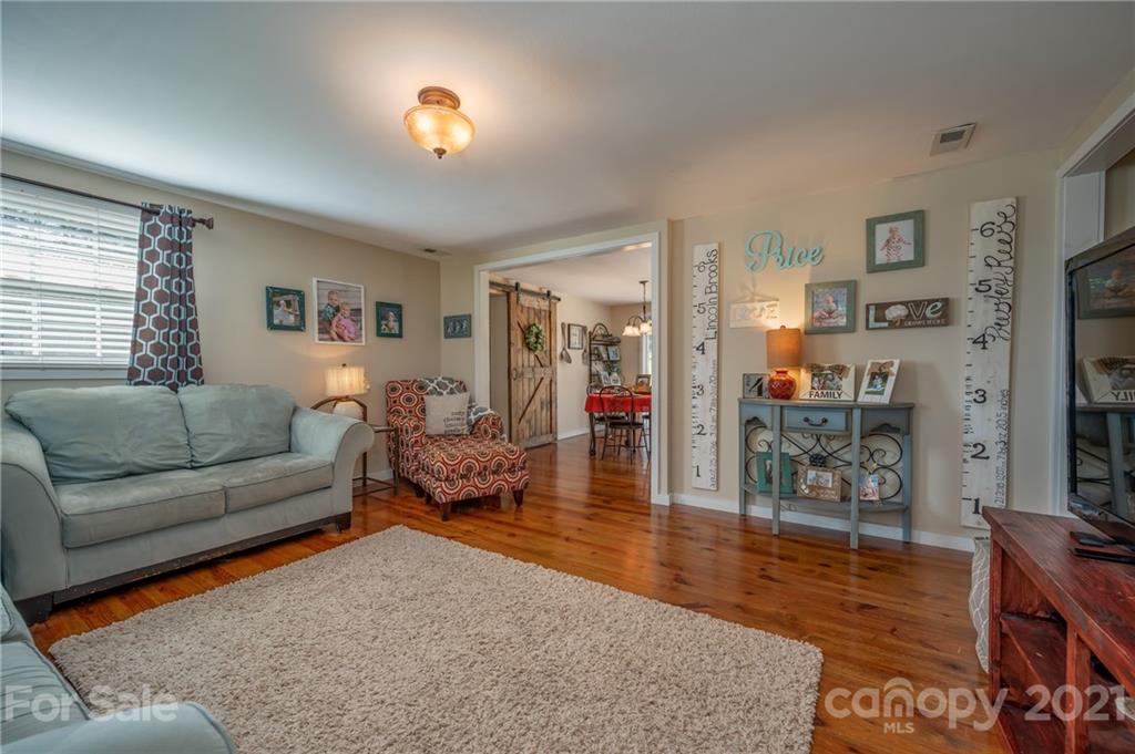 455 Sandy Plains Road Tryon, NC 28782 - Photo 8 of 28 a living room with furniture and a flat screen tv