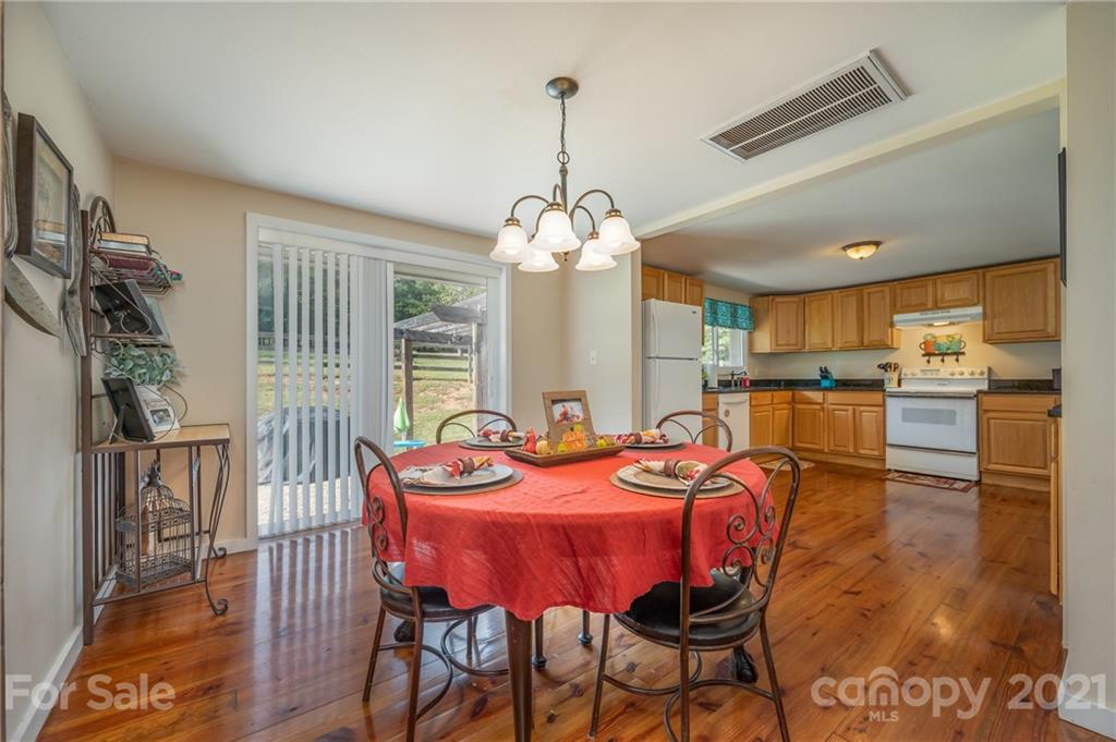 455 Sandy Plains Road Tryon, NC 28782 - Photo 9 of 28 a view of a dining room with furniture window and wooden floor