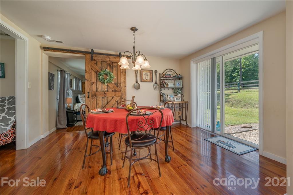 455 Sandy Plains Road Tryon, NC 28782 - Photo 10 of 28 a view of a dining room with furniture window and wooden floor