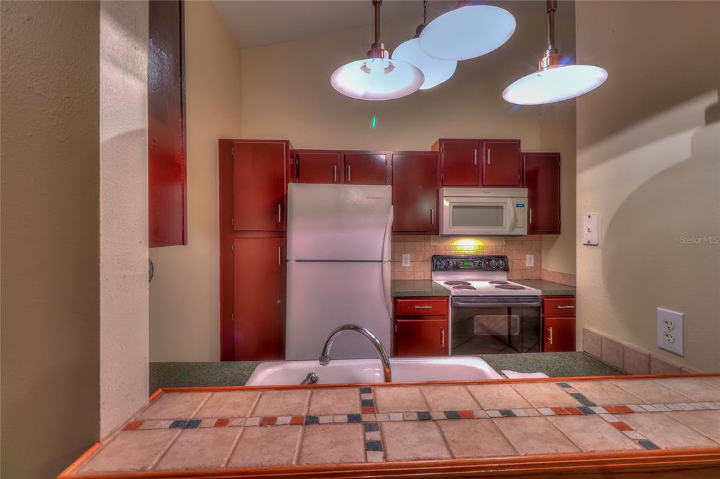 5100 Burchette Road, Unit 1607 Tampa, FL 33647 - Photo 19 of 39 a bedroom with a bed and a chandelier