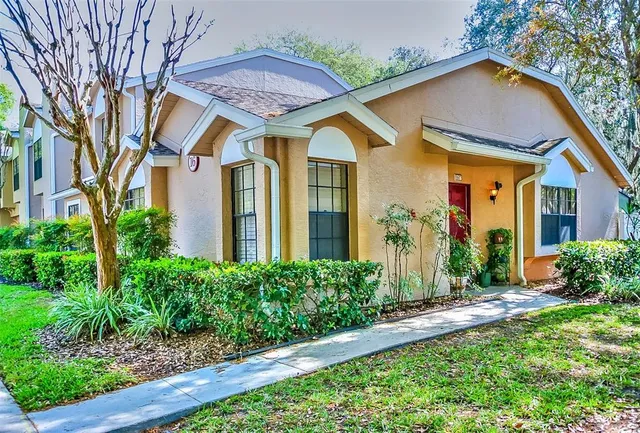 a front view of house with a garden