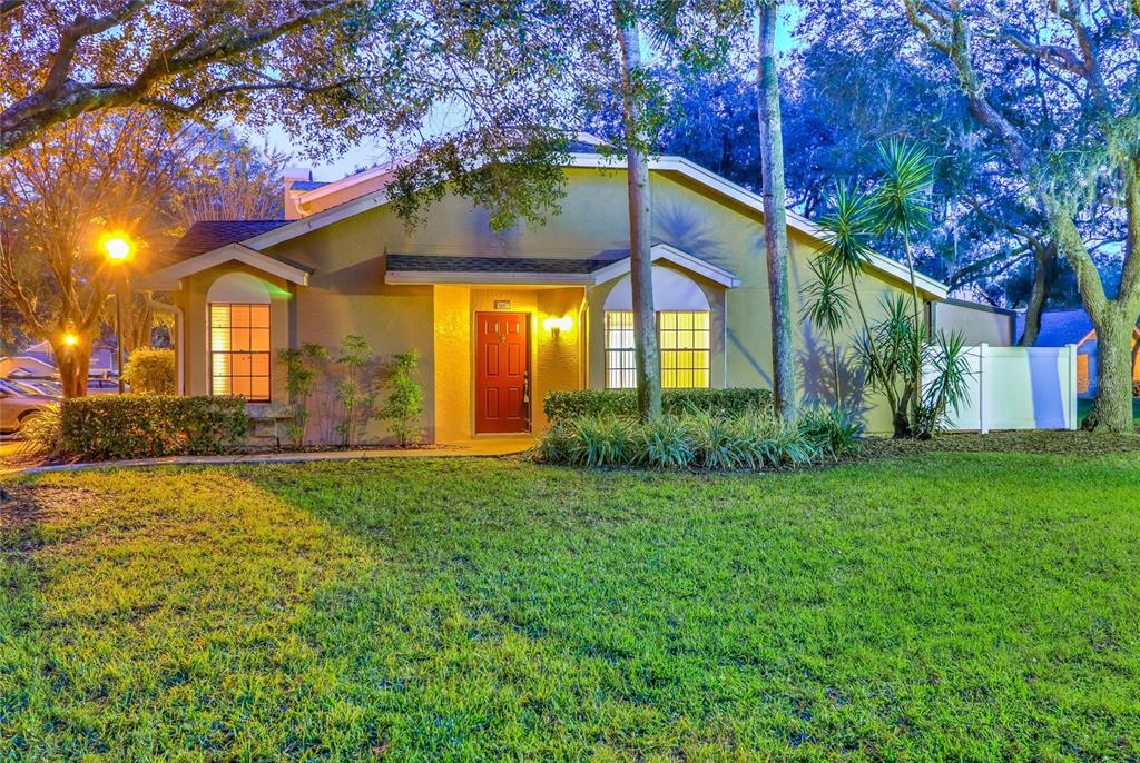 5100 Burchette Road, Unit 1607 Tampa, FL 33647 - Photo 7 of 39 a view of a house with a small yard and large trees
