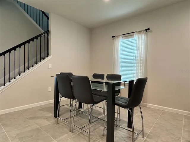 a kitchen with kitchen island a dining table and chairs