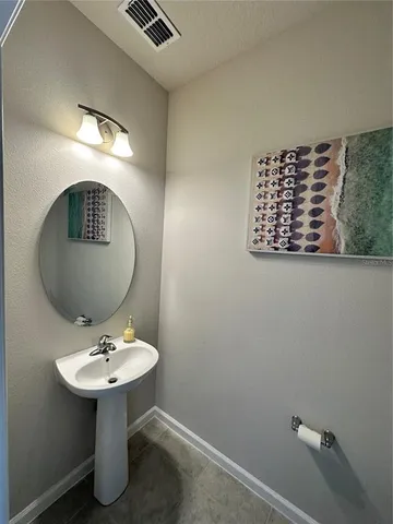 a white toilet sitting next to a bathroom sink