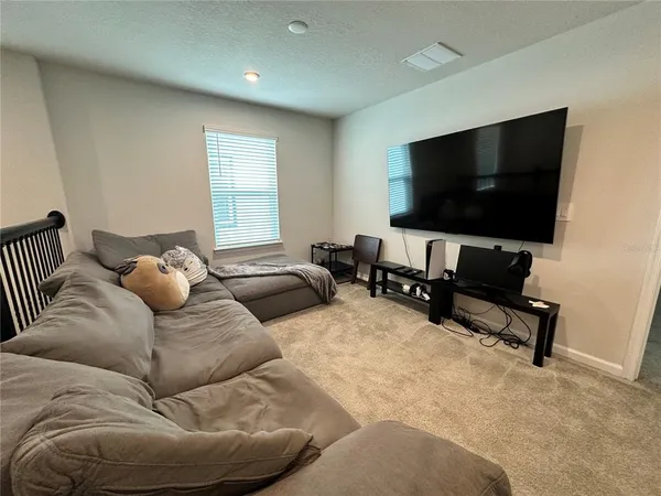 a spacious bedroom with a bed and a chandelier