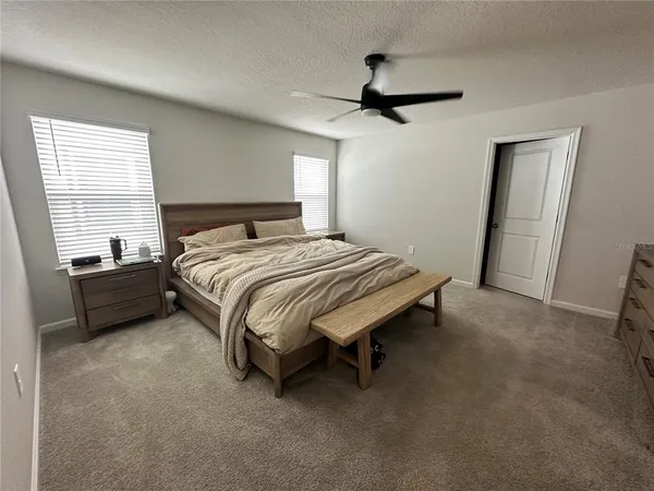 a bedroom with a bed and a mirror