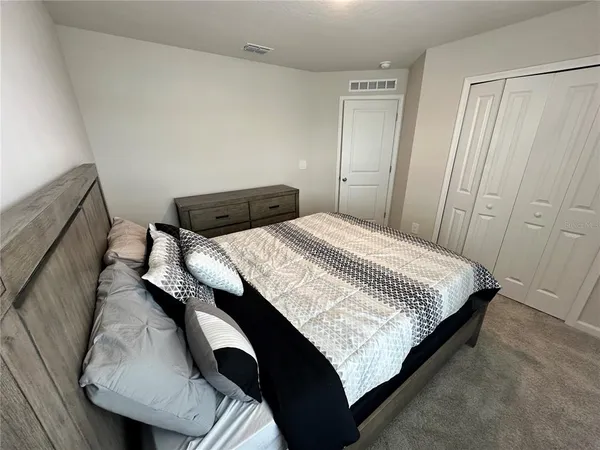 a bed sitting in a bedroom next to a window