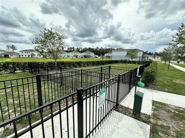 a view of a terrace with lawn chairs