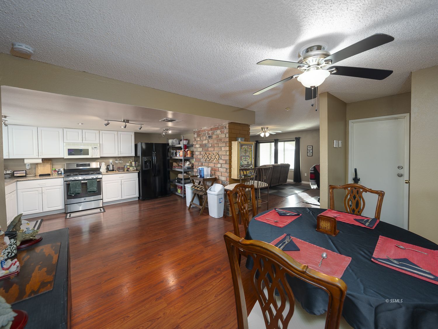800 South Sanders Street Ridgecrest, CA 93555 - Photo 6 of 33 a view of a dining room and livingroom with furniture wooden floor a chandelier