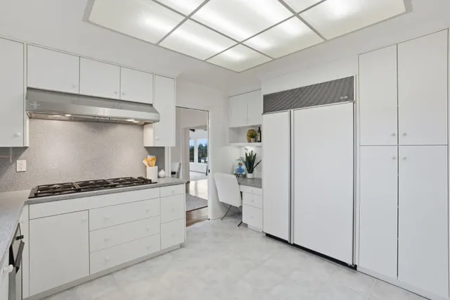 a bathroom with a granite countertop sink a toilet and a mirror