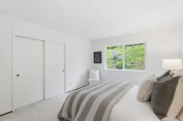 a spacious bedroom with a large bed and a large window