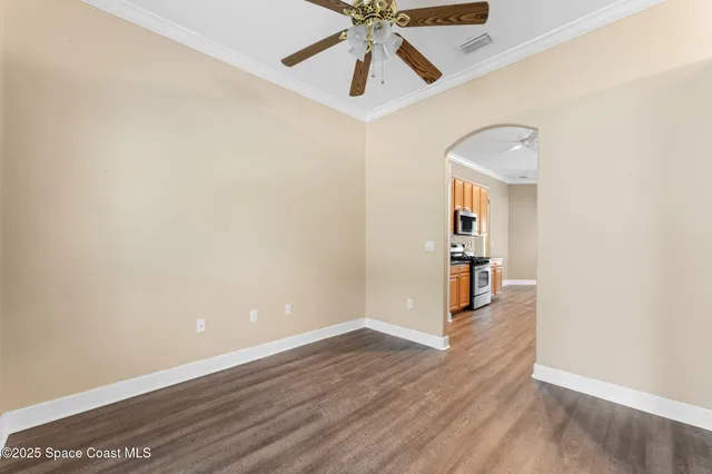 a kitchen with stainless steel appliances granite countertop a refrigerator a stove top oven a sink and dishwasher with wooden floor