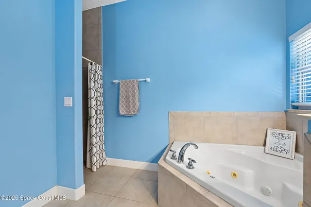 an empty room with a empty space and chandelier fan