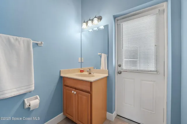 a spacious bathroom with a double vanity sink and a mirror