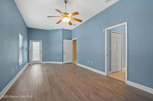 a view of a hallway with closet and chandelier