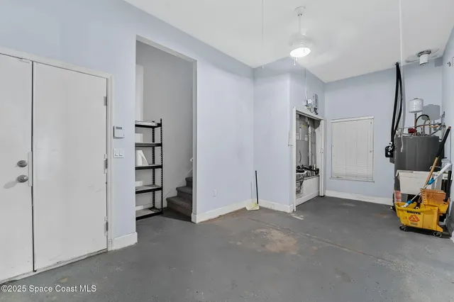 a view of a house with a yard and large tree
