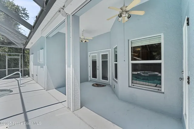 an aerial view of residential houses with outdoor space and trees