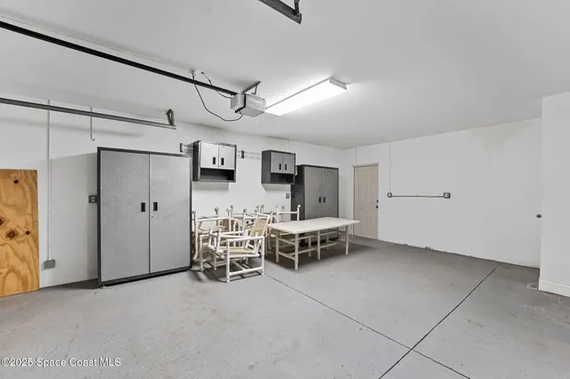 an aerial view of a house with a yard and large trees