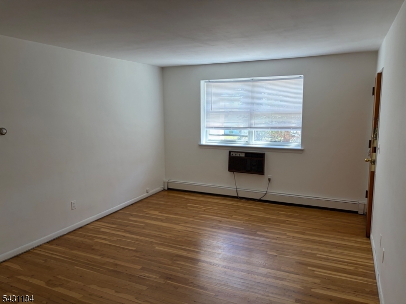 199 North Beverwyck Road Lake Hiawatha, NJ 07034 - Photo 1 of 7 wooden floor in an empty room with a window