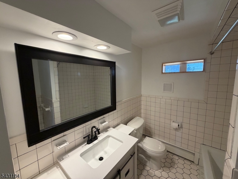 199 North Beverwyck Road Lake Hiawatha, NJ 07034 - Photo 5 of 7 a bathroom with a toilet sink and mirror