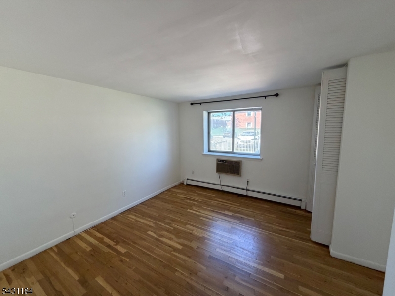 199 North Beverwyck Road Lake Hiawatha, NJ 07034 - Photo 6 of 7 an empty room with wooden floor and windows
