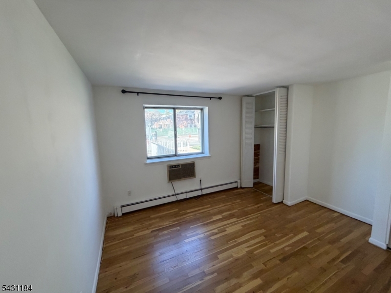 199 North Beverwyck Road Lake Hiawatha, NJ 07034 - Photo 7 of 7 an empty room with wooden floor and windows
