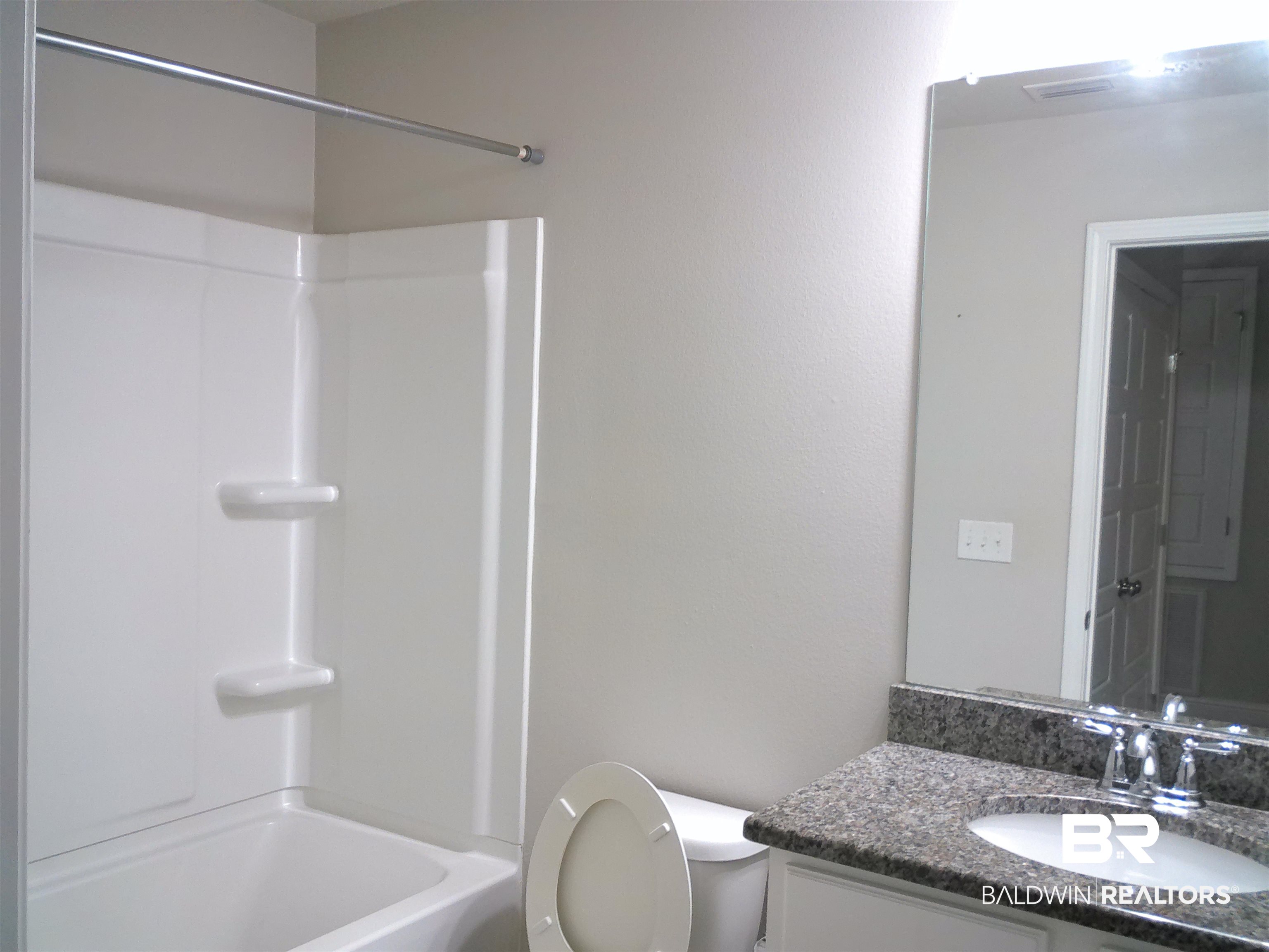 25806 Pollard Road, Unit 23 Daphne, AL 36526 - Photo 10 of 16 Bathroom featuring vanity and washtub / shower combination