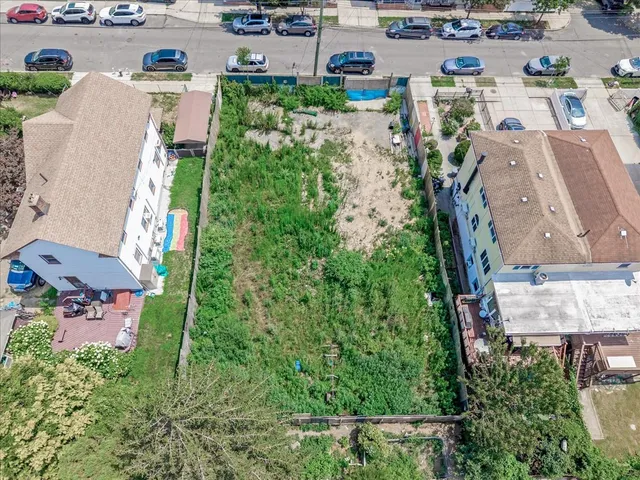 an aerial view of a house with a yard basket ball court and outdoor seating