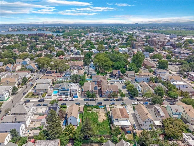 an aerial view of residential building with green space